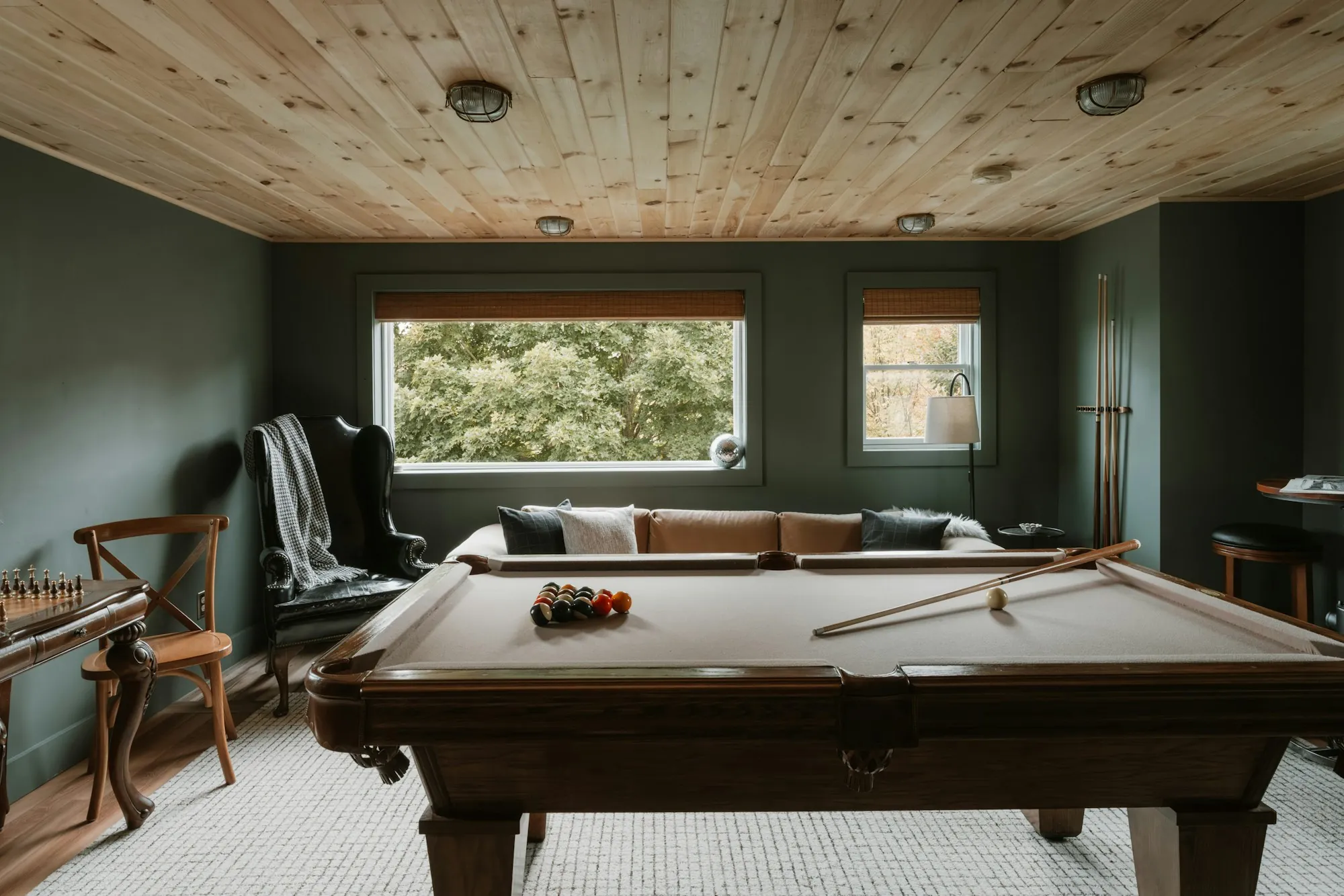 Finished basement family room with recessed lights and a sectional sofa