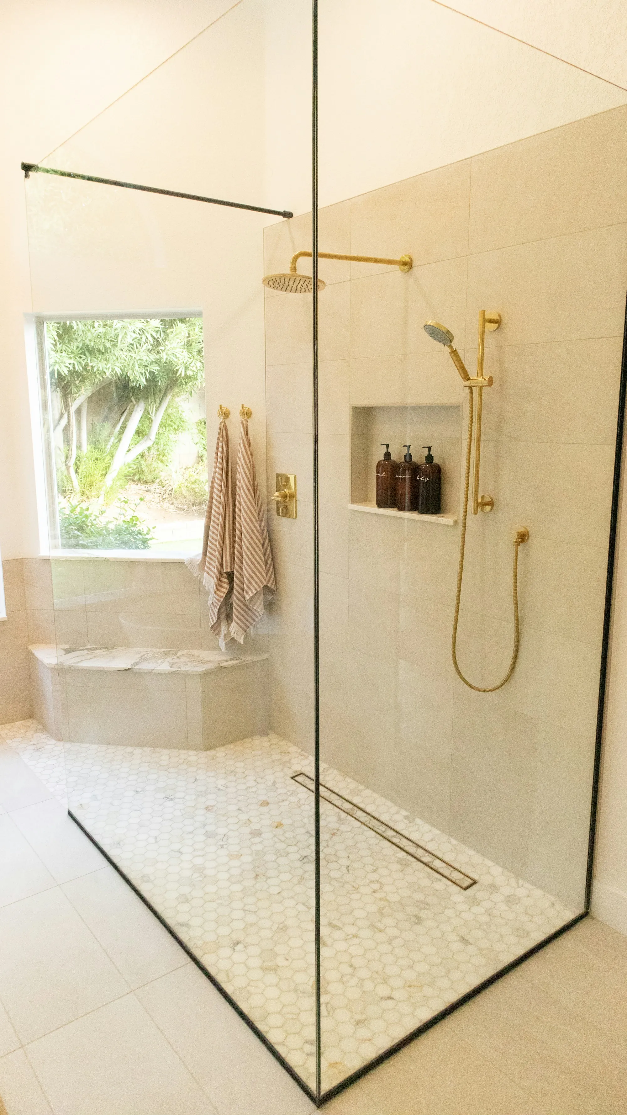 Remodeled bathroom with a tiled walk-in shower and a floating vanity